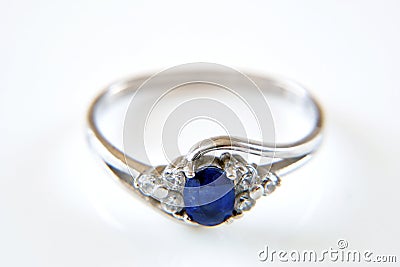 Earring and ring set with big blue sapphire and white diamonds around, jewerly shop, pawnshop concept Stock Photo
