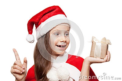 A 7 ears old Little Girl with Christmas Gift thinkig of What Santa Bring to Her. . Stock Photo