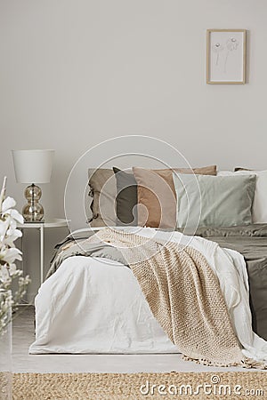 Earth colors in stylish bedroom interior with king size bedr Stock Photo