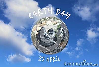 Earth day concept. Globe in the sky with clouds. Text 'Earth day, April 22.' Stock Photo