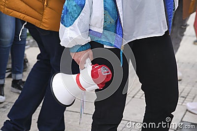 Earth Day demonstration, young person holding a megaphone; activism, protest Editorial Stock Photo