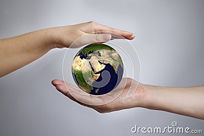 The Earth in a female and male hands Stock Photo
