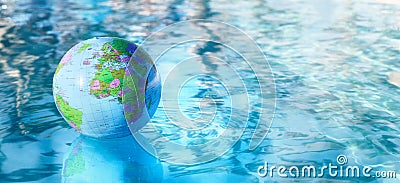Earth globe beach ball floating on water surface Stock Photo