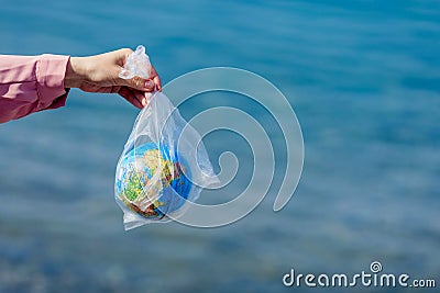 The Earth in a plastic bag. World Environment Day concept. Stock Photo