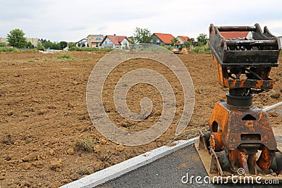 Earth rammer and prepared soil for the construction of a new house. Stock Photo