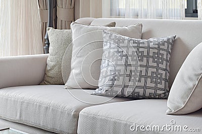 Earth tone sofa set with varies pattern pillows in living room Stock Photo