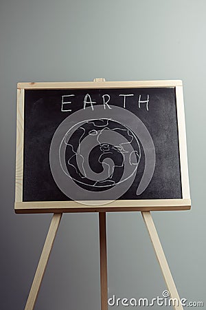 earth written on blackboard with earth symbol, background, high resolution Stock Photo