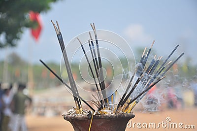 Earthen lamps and incense sticks in a temple with some flowers to worship lord Shiva Stock Photo