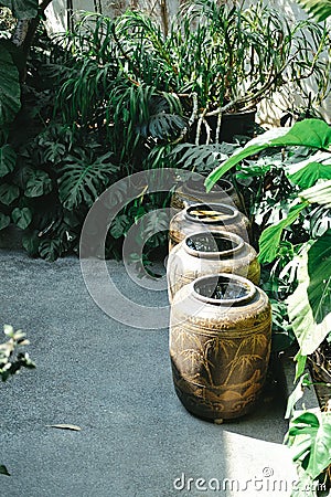 Earthen water jar in garden. rain pot reservoir Stock Photo