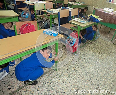 Earthquake maneuver elementary school boys. Earthquake maneuver in elementary school boys Editorial Stock Photo