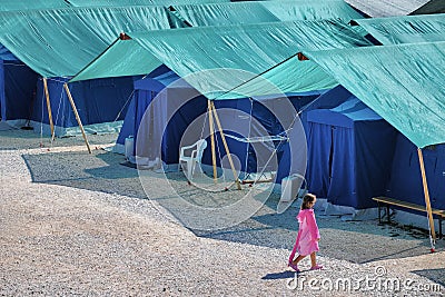 Earthquake refugees tent camp with lonely child walking Editorial Stock Photo
