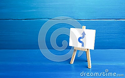 An easel with a curved arrow avoiding an obstacle. Deviation from route, side mission. Maneuvering, taking right action. Stock Photo