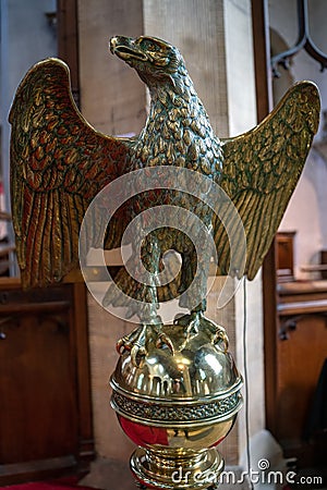 Decorative brass eagle lectern in St Swithuns Church , East Grinstead, West Sussex on Editorial Stock Photo
