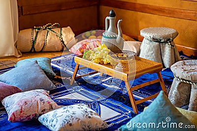 East. small table with jug and grapes. traditional textiles Stock Photo