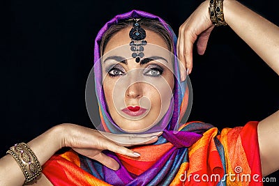 East woman in burqa with jewels on a black background Stock Photo