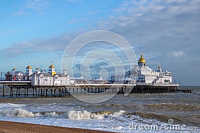 View of Eastbourne Pier in East Sussex on January 7, 2018. Four unidentified people Editorial Stock Photo