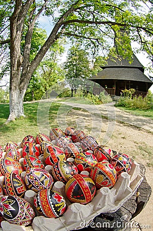 Easter. Hand painted eggs and traditional orthodox wooden church Barsana Monastery - landmark attraction in Maramures, Romania Stock Photo