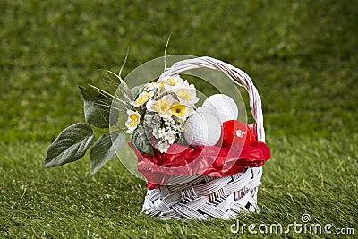 Easter Basket with Golf Balls and Flowers Stock Photo