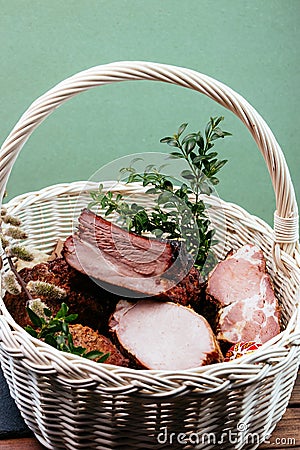 Easter basket with smoked meat. Stock Photo