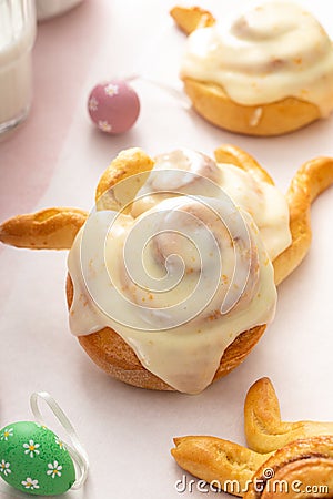 Easter breakfast rolls with orange glaze shaped like a bunny Stock Photo