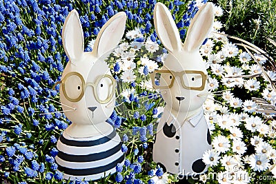 Happy easter- Easter bunnies in blue grape hyacinths, white anemones Stock Photo