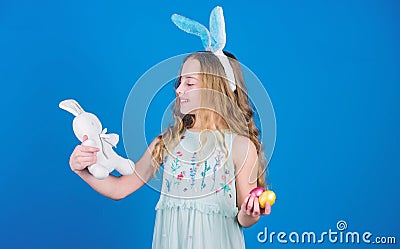 The Easter bunny is coming. Easter bunny rabbit. Little girl and rabbit toy. Small girl in rabbit ears with Easter toy Stock Photo