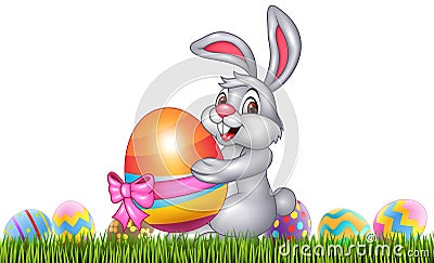 Easter bunny with decorated Easter eggs in a field Vector Illustration