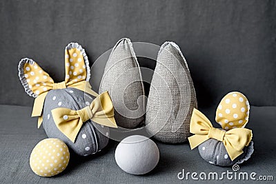 Easter Bunny ears from napkins and eggs. Quail and chicken eggs. Gray textile background. Happy easter Stock Photo