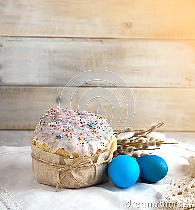 Easter cake on a light background, in a rustic style with blue eggs and beautiful sprigs of willow on a white napkin Stock Photo