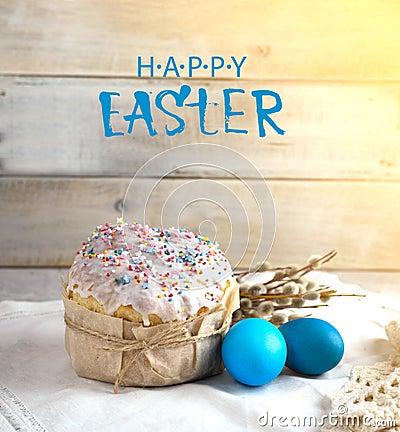 Easter cake on a light background, in a rustic style with blue eggs and beautiful sprigs of willow on a white napkin Stock Photo