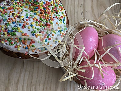 Easter cake paska in straw and the coloured eggs krashanka Stock Photo