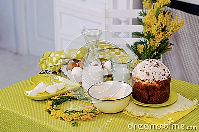 Easter cake products on the green table with flowers Stock Photo