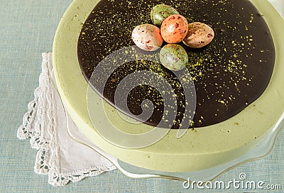 Easter cake with tea matcha decorated chocolate ganache and sweet-stuff eggs Stock Photo