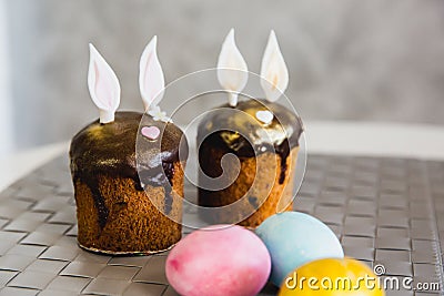 Easter Cakes decorated with bunny ears and colorful eggs. Traditional Kulich, Paska Easter Bread Stock Photo