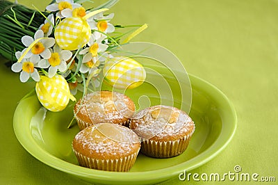 Easter cakes on plate with flowers on green Stock Photo
