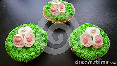 Easter Cakes. Symbolize The Easter Bunny, Which Is Hidden In The Grass, And Outside Protrude Paws And Tail Stock Photo