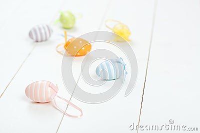 Easter card. Scattered pastel Easter eggs on a wooden background. Stock Photo