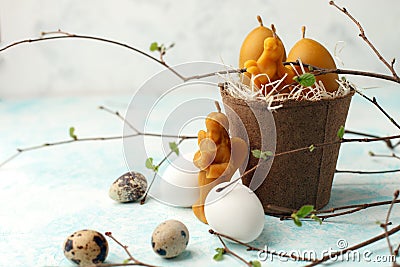 Easter celebration table setting, stylized photo - eggs and decorative natural wax candles - angel, rabbit, egg on light Stock Photo