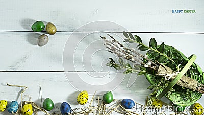 Easter colorful eggs with basket on white wooden background Stock Photo