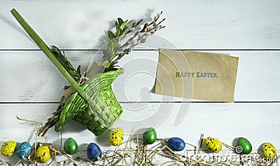 Easter colorful eggs with basket on white wooden background Stock Photo