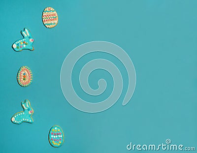 Border of delicious homemade cookies in the form of Easter bunnies and eggs on a light blue background. Stock Photo