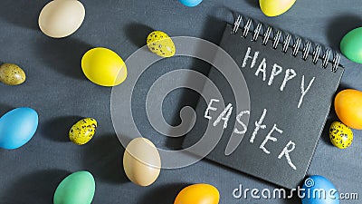 Easter composition with colorful eggs on a dark blue background. Stock Photo