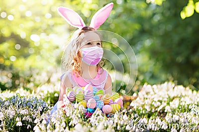 Easter in covid-19. Child in face mask, bunny ears Stock Photo