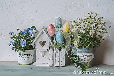 Easter decor with bird house and spring flowers Stock Photo