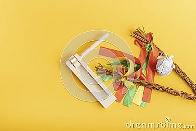 Easter whips, egg and rattle clapper on orange background, flat lay, top view Stock Photo