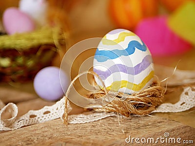 Easter decoration, painted eggs, yellow vegetables, pumpkins on a wooden light table Stock Photo