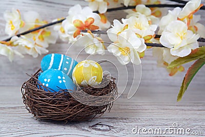 Easter decorations. Eggs in nests on wood Stock Photo