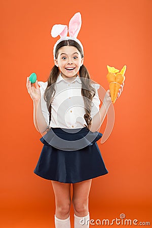 Easter dinner. easter carrot recipes. stay healthy and happy. small girl hold carrot and eggs. egg hunt began. child in Stock Photo