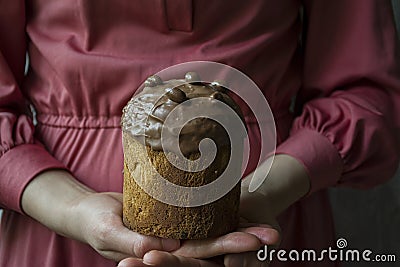 Easter, Easter cake chocolate. Kulich in female hands. Traditional Kulich, Easter Bread. Spring holiday in memory of the Stock Photo