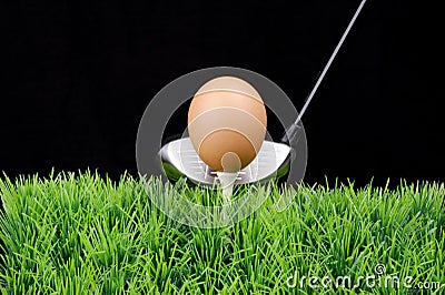 Easter egg on golf tee with golf driver Stock Photo